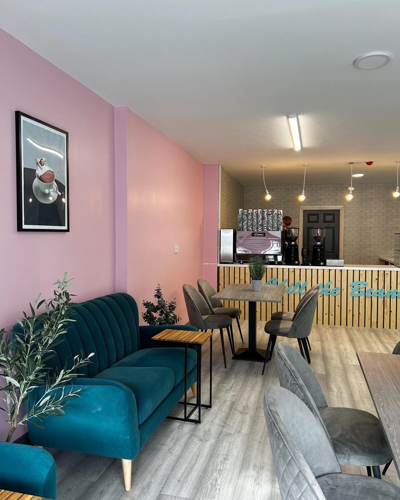 Inside the shop — teal banquette seating and pink walls